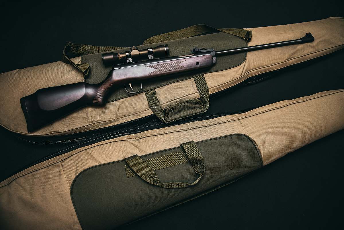 gun bag brown and black sniper rifle with beige bag scope